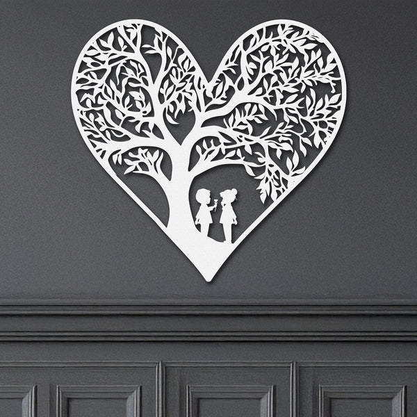 Close-up of white metal heart wall art with intricate tree and children design.