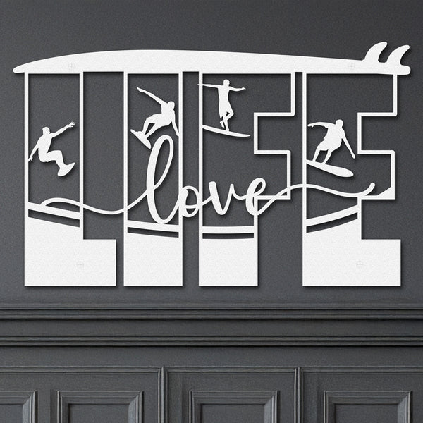 White decorative metal wall art featuring the word 'LIFE' with silhouettes of surfers in various poses within each letter, and the word 'love' written in cursive script in the center the words are under a surfboard.