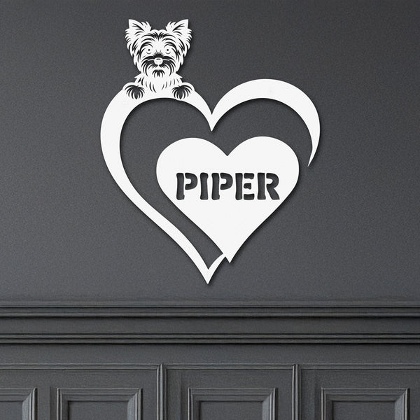 White metal sign featuring a yorkie and a heart-shaped name plaque, displayed on a dark background.