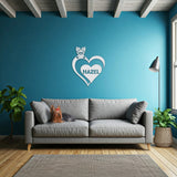 White metal sign with a Yorkshire Terrier silhouette peeking over a heart, with the name
