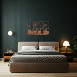 Copper decorative metal wall art featuring the word 'LIFE' with silhouettes of surfers in various poses within each letter, and the word 'love' written in cursive script in the center hanging on a wall behind a bed.