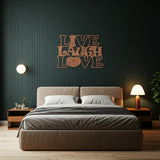 Metal die-cut sign with the phrase 'Live Laugh Love' in a bedroom setting with a modern bed and side tables.