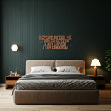 Metal die-cut sign with the phrase 'Repeat After Me I Am Grateful I Am Loved I Am Enough' in a bedroom setting with a modern bed and side tables.