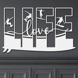 White decorative metal wall art featuring the word 'LIFE' with silhouettes of surfers in various poses within each letter, and the word 'love' written in cursive script in the center.
