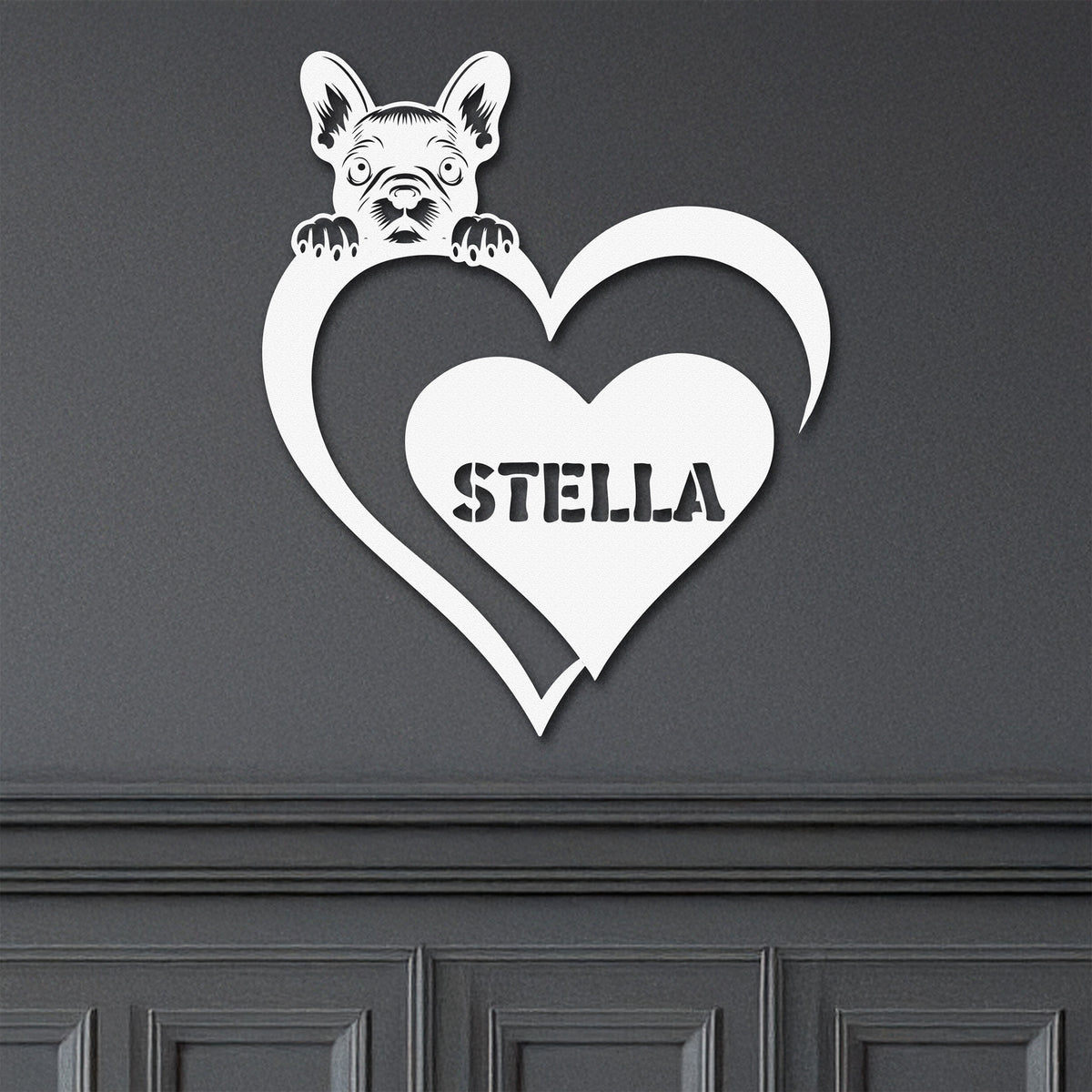 White metal sign featuring a pug and a heart-shaped name plaque, displayed on a dark background.