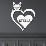 White metal sign featuring a pug and a heart-shaped name plaque, displayed on a dark background.