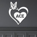 White metal sign with a German Shepard dog silhouette peeking over a heart, with the name 