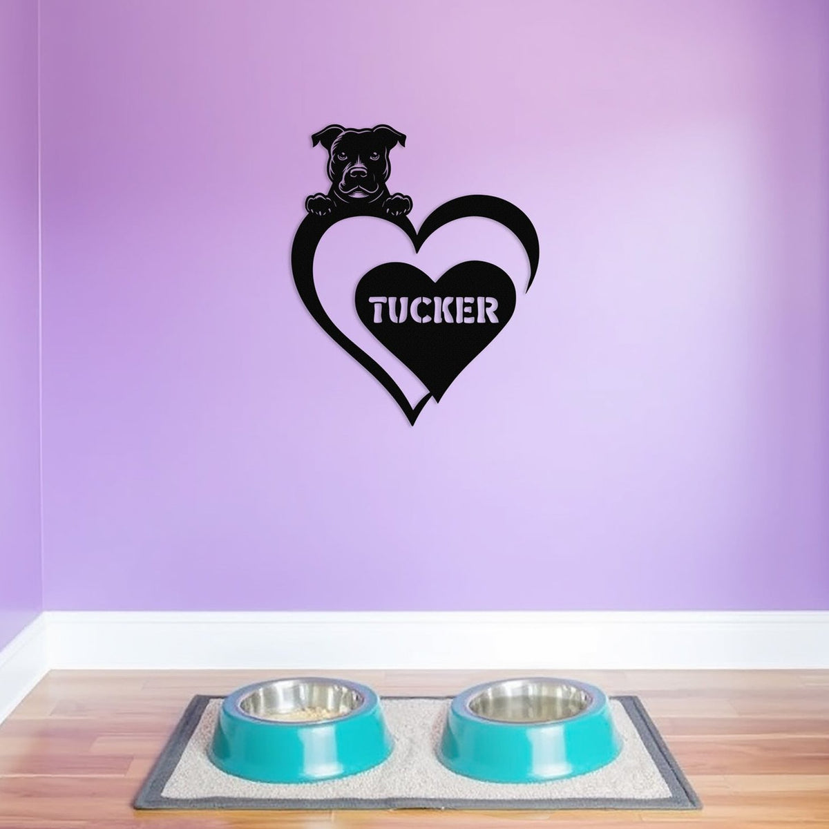 Personalized metal sign featuring a pit bull and a heart-shaped name plaque, displayed on a purple wall above dog bowls.