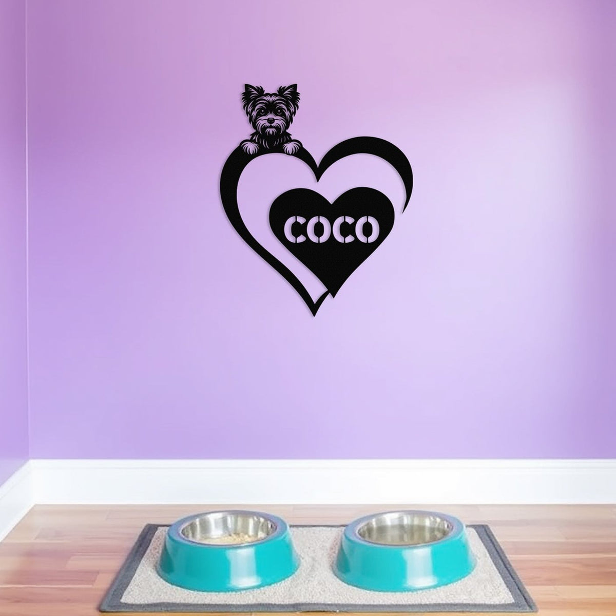 Personalized metal sign featuring a yorkshire terrier and a heart-shaped name plaque, displayed on a purple wall above dog bowls.