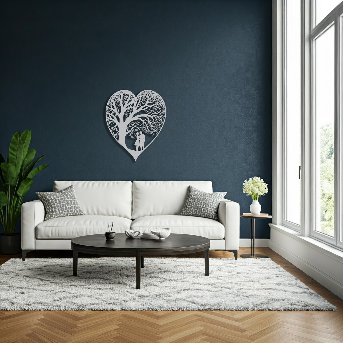 An additional view of the metal heart-shaped wall decor with a detailed tree-like patternthis time is silver in a living room setting.