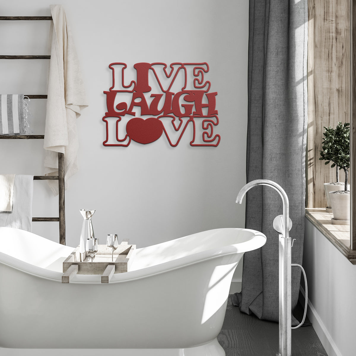 Red metal wall art the says " Live laugh ove" with a heart symbol for the "o", hanging ona white bathroom wall.