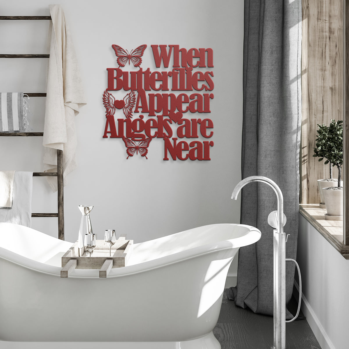 Red wall decor with a cutout butterfly and the quote "When Butterflies Appear, Angels are Near" hanging beside a white bathtub.