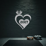 White metal sign with a dog silhouette peeking over a heart, with the name 