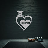 Silver metal sign with a dog silhouette peeking over a heart, with the name 