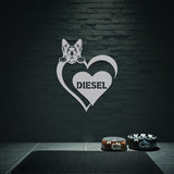 Silver metal sign of a German Shepard dog silhouette peeking over a heart, with the name 